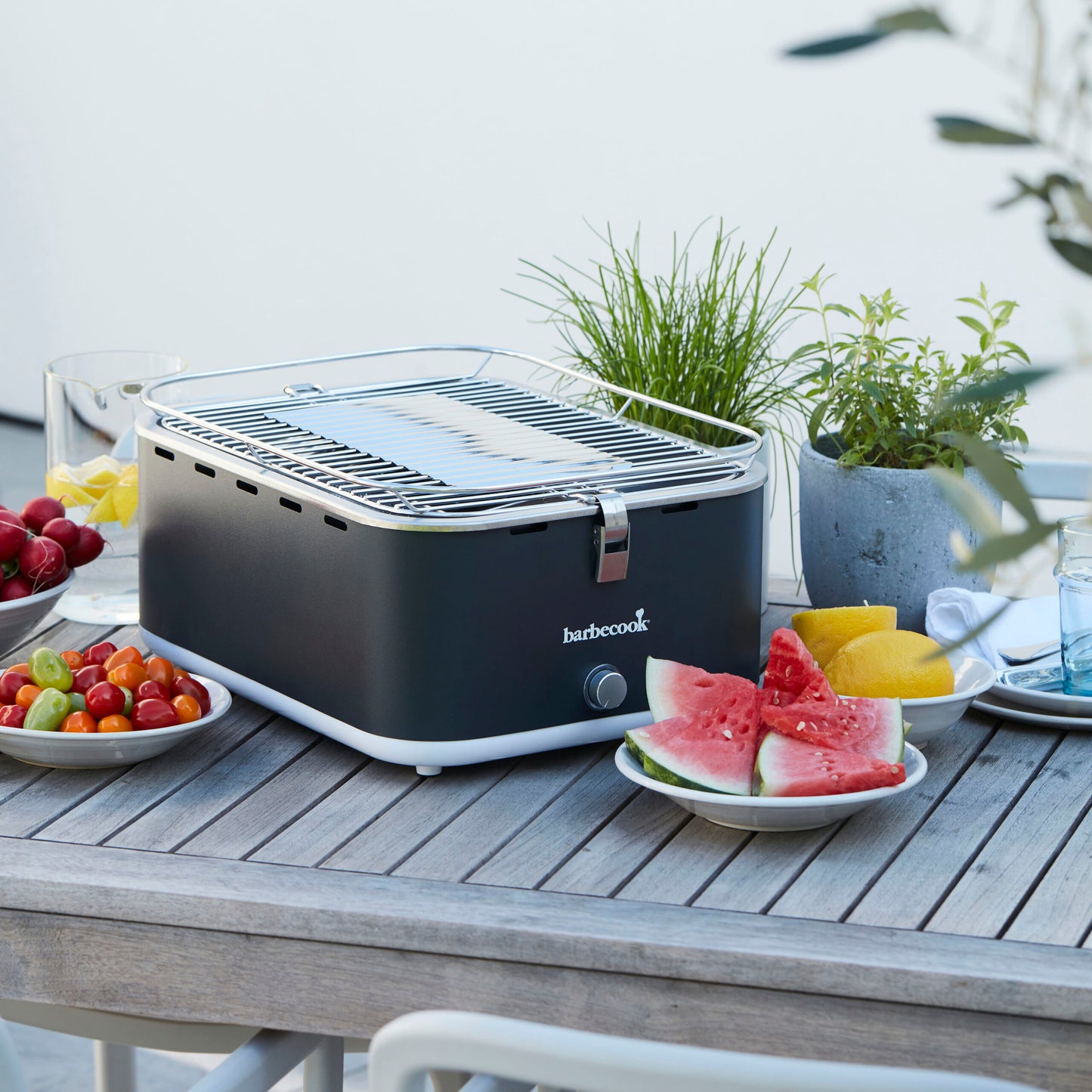 Barbecook Carlo charcoal table grill Urban Grey 44x33x21cm on table